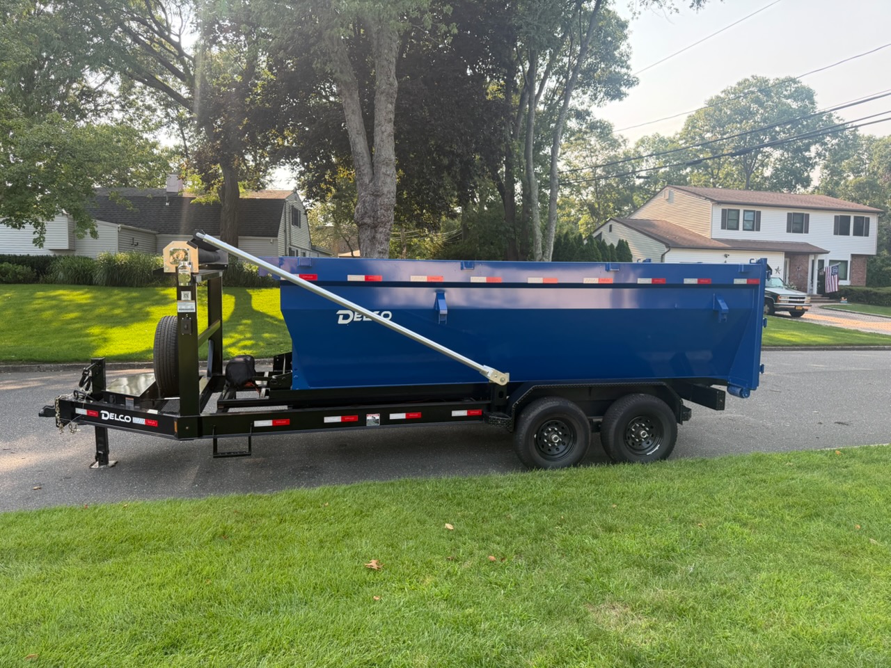 Blue Delco dumpster trailer rental delivered for residential cleanout on Long Island New York