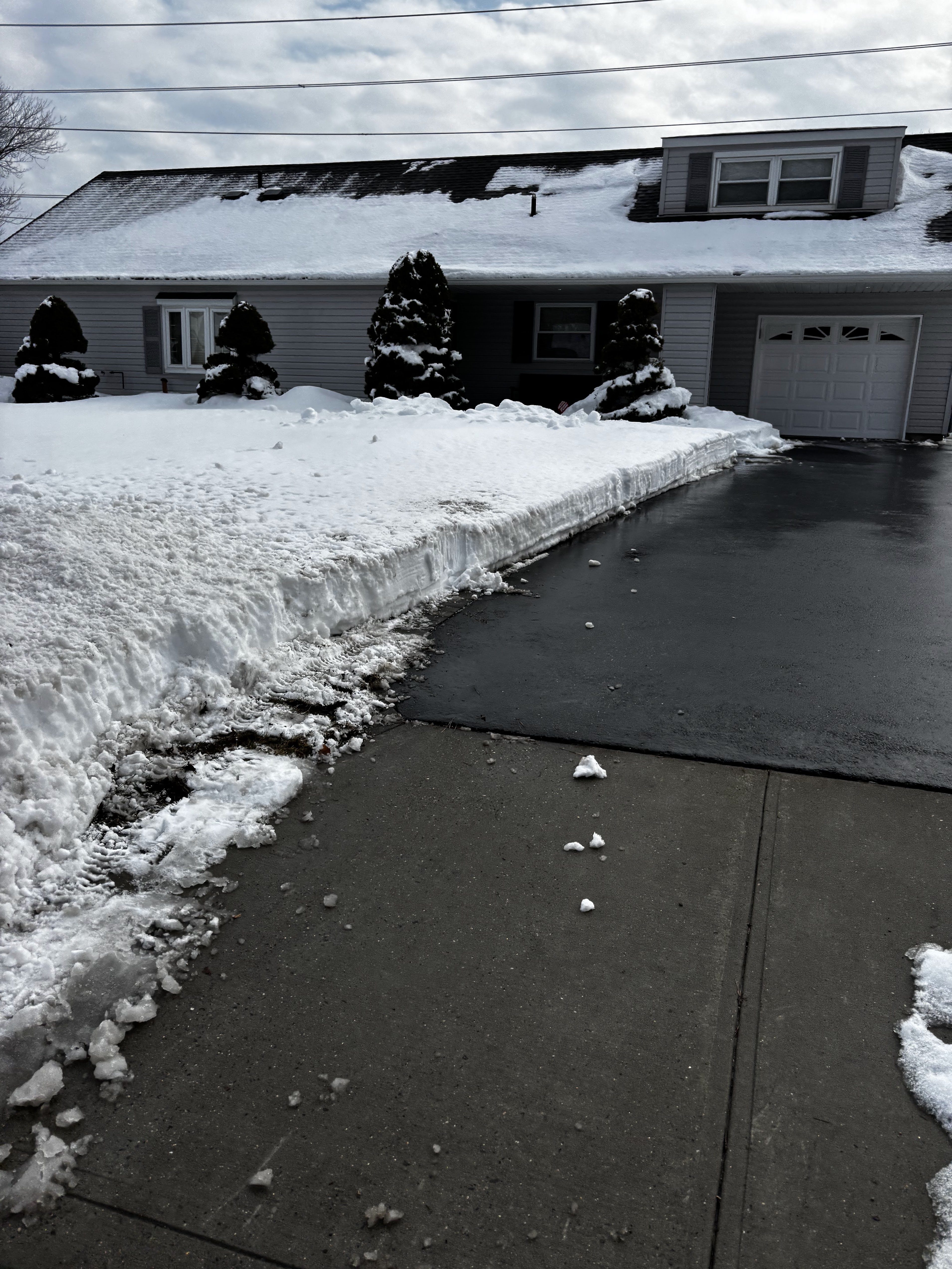 Residential driveway fully cleared after professional snow removal service on Long Island NY