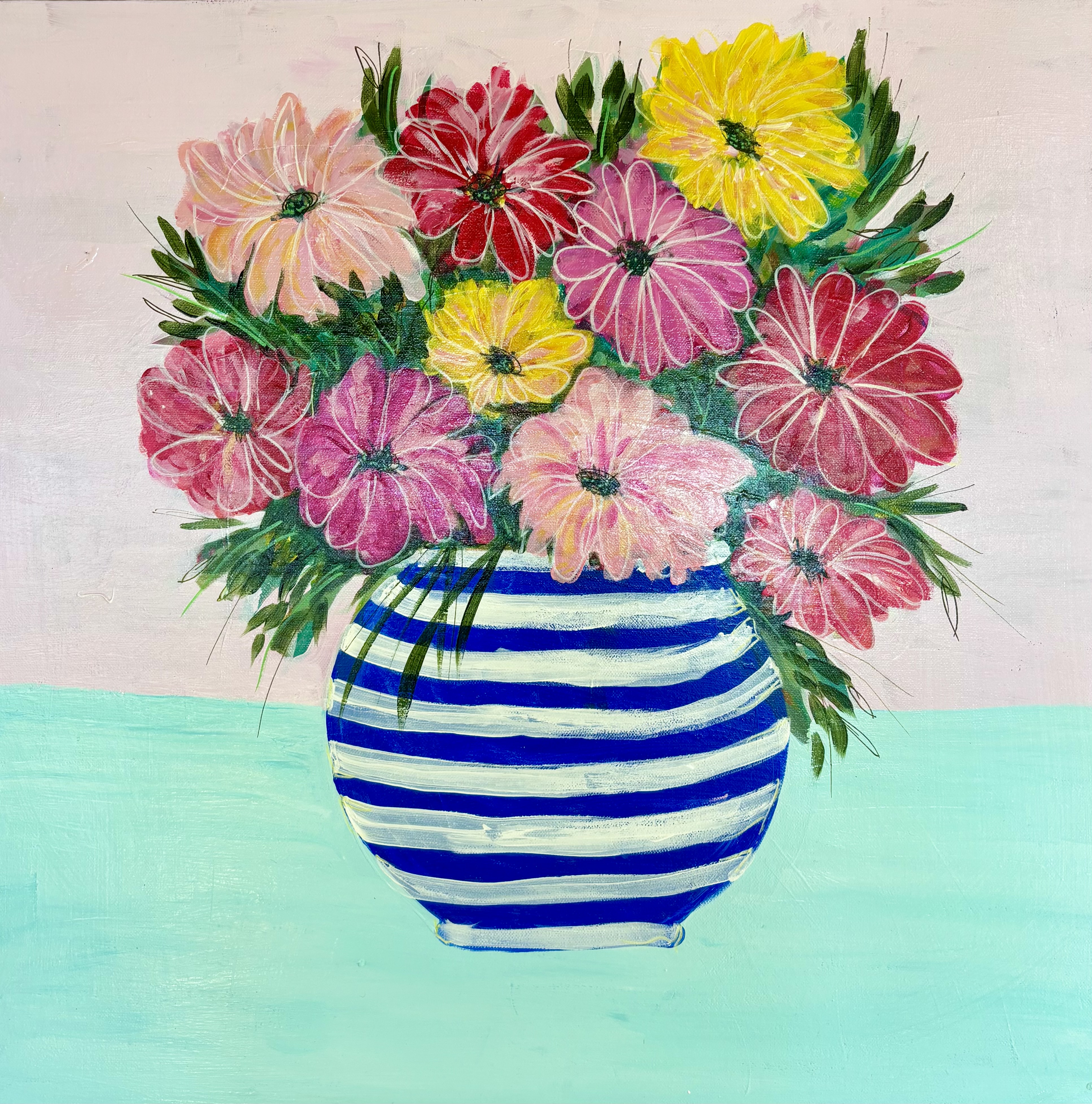 Colourful flowers in a blue and white striped vase